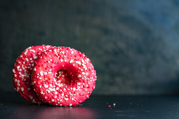donut pink icing and strawberry berry filling ready to eat portion on the table for healthy meal...
