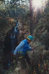 Man taking a selfie while dangling from a rope canyoning