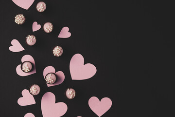 hearts and candy on a black background. the theme of the Valentine's day