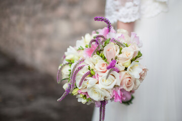 Bridal bouquet Beautiful of white roses in hands of the bride. Lifestyle image. Place for text. Selective focus