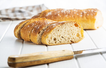 Crispy fresh baguettes. Sliced baguette.