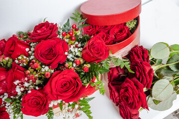 Various romantic gifts for Valentine's Day. Bouquet of red roses, floral box. Special gift for Valentine's Day, anniversary and birthday. Surprise for loved ones, proof of love