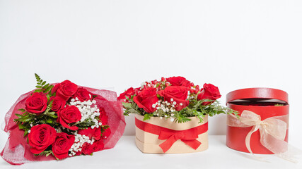 Various romantic gifts for Valentine's Day. Bouquet of red roses, floral box. Special gift for...