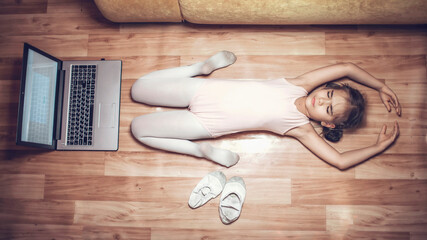 Online hobby, fitness, distant training. Young ballerina practicing classic choreography during online ballet class at home before laptop, social distance during quarantine, online education © Maria