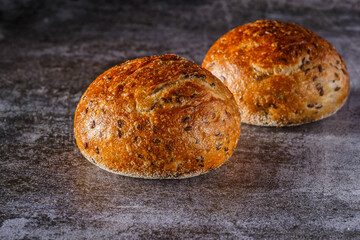 Assortment of baked bread on wooden table background Fresh fragrant bread on the table. Food concept.