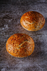 Assortment of baked bread on wooden table background Fresh fragrant bread on the table. Food concept.