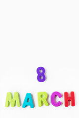 flat lay of text 8 march made of plastic magnetic letters isolated on wgite background. international woman day concept. space for text and congratulation. post card.