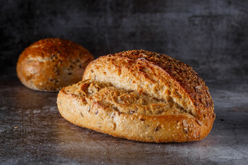 Assortment of baked bread on wooden table background Fresh fragrant bread on the table. Food concept.