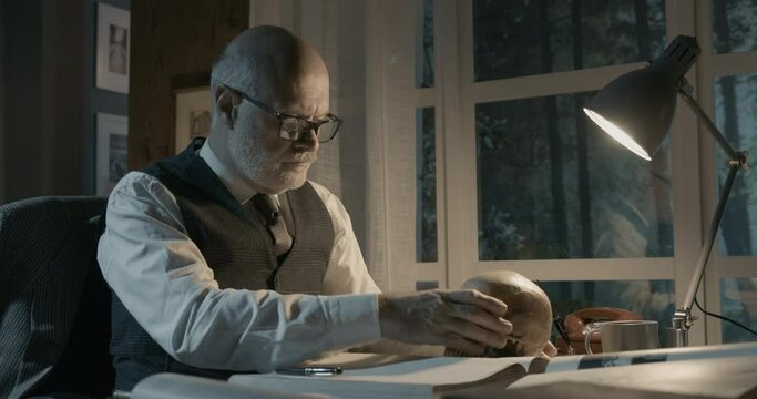 Academic professor studying a human skull