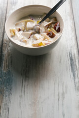 Healthy and nutritious homemade breakfast - fruit yogurt with apples and walnuts. Copy space left.