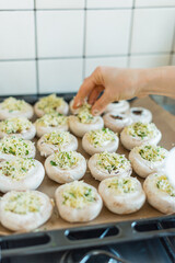 Photo of woman preparing mushrooms at home.