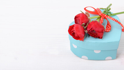 Valentines gift with red ranunculus on a white background, Celebration Valentine's day, holiday, anniversary of married couple, birthday background