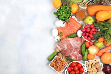 Healthy balanced food with dietary ingredients, vegetables, fruits, nuts, meat, fish for weight loss, healthy lifestyle concept, place for text, selective focus