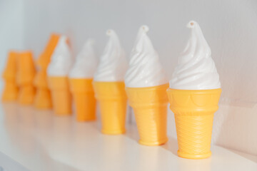 The plastic ice cream cones from the playroom. Small toys for kids in the kindergarten. Eating items for the game. Collection of waffles with milk ice cream, as a summer concept.