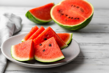 Fresh watermelon fruit slices against white wooden background