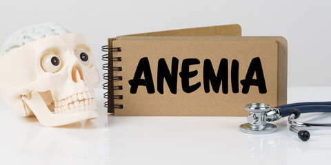 On the table lies a skull, a stethoscope and a notebook with the inscription - ANEMIA