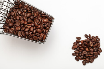 Coffee beans inside small shopping cart on white background