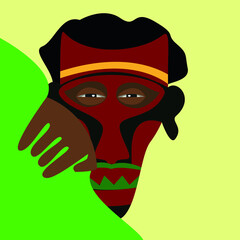 the face under mask of a man from an African tribe who is spying on someone in the bushes