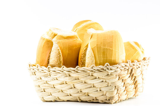 A basket full of traditional Brazilian bread, called "French Bread Cacetinho", traditional concept of Brazilian food, isolated white background