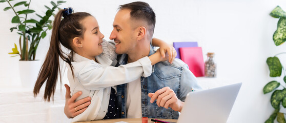 young father help little preschooler daughter studying together watch online lesson on laptop, dad...