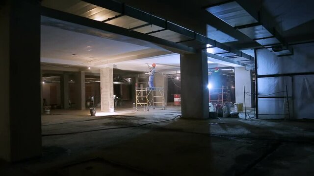 Repair inside the building. Worker plasters ceiling