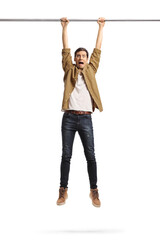 Young man hanging from a metal bar