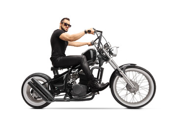 Obraz na płótnie Canvas Man with sunglasses riding a chopper motorbike