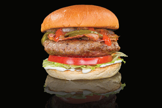 Delicious burger with meat, vegetables, and sauce with reflection