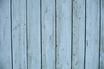 Stock photo of a painted wooden textured background of a shed. Light blue wooden planks.