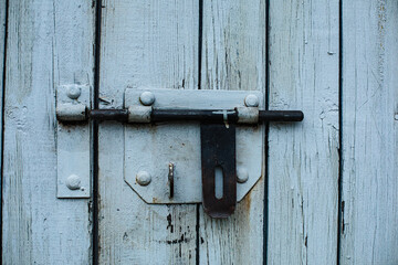 A wooden fence, a door. White vertical boards