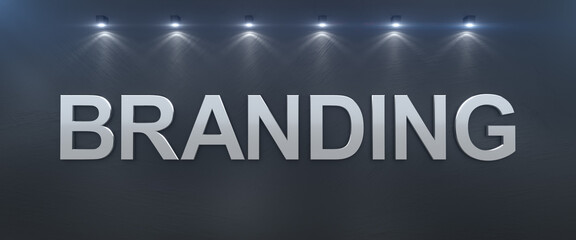 Word branding written on black wall with silver letters.