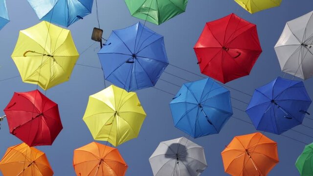 Collection of colorful umbrellas on sky background