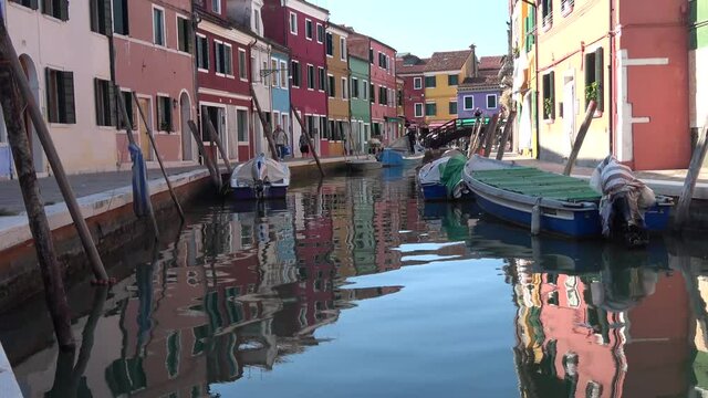BURANO - SEPTEMBER 26: Real time establishing shot of a canal with colorful houses on the island of Burano in Italy. Burano island is famous for its colorful houses