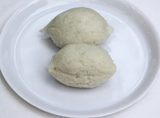 Selective focus on one of Imbul Kiribath,a cylindrical shape Sri lankan sweet dish made from rice,coconut milk and sweet filling