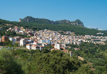 Cityscape of old pictoresque colorful village Jerzu with limestone rocks, mountains and green forest vegetation. Summer sunny day. Province of Nuoro, Sardinia, Italy, Europe