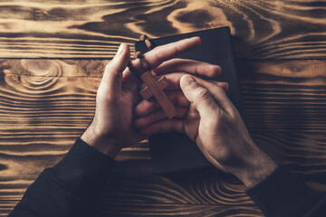 prayer man hand cross on Holy Bible