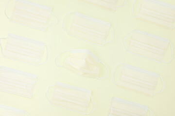 Yellow masks on yellow lemon paper background. Creative concept background. Pattern. Flat lay. High quality photo