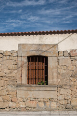 window of an old house, stone wall