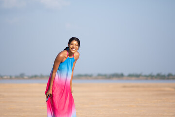 beautiful african lady feeling happy and excited at the beach