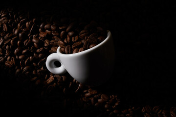 Taza de café con granos. Luz direccional