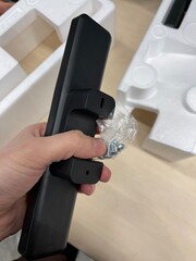 hand holds a piece of plastic and bolts