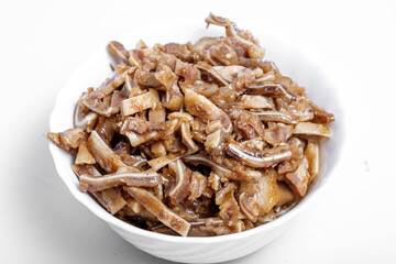 Appetizing beer snack - smoked pork pig ears on a board on a gray background