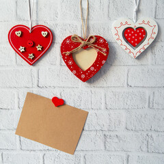 decorative red valentine and craft card for text on white brick background. valentines day concept