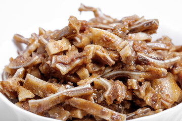 Appetizing beer snack - smoked pork pig ears on a board on a gray background
