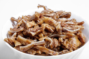 Appetizing beer snack - smoked pork pig ears on a board on a gray background