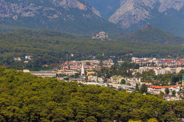 Obraz premium View of Kemer town on a coast of the Mediterranean sea in Antalya province, Turkey. Turkish Riviera. View from a mountain
