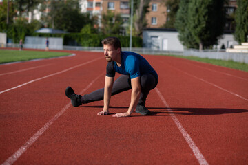 Handsome guy doing stretching before jogging