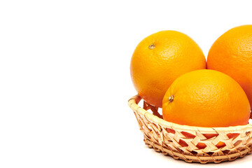 Group of delicious and healthy ripe oranges in a basket isolated