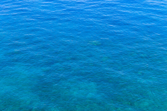 Blue water texture background. Surface of the sea © olyasolodenko