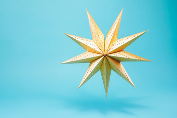 Eight pointed gold star isolated on blue background